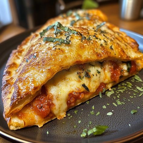 Chicken Parmesan Calzone 🍗🍅🧀 Ingredients: For the Filling: 1 lb cooked chicken breast, shredded or diced 1 cup marinara sauce 1 1/2 cups shredded mozzarella cheese 1/2 cup grated Parmesan cheese 1 tsp garlic powder 1 tsp Italian seasoning Salt and pepper, to taste Fresh basil (optional, for garnish) For the Dough: 1 lb pizza dough (store-bought or homemade) 1 tbsp olive oil (for brushing) For Garnish (optional): Extra marinara sauce for dipping Grated Parmesan cheese Instructions : Prehea... Fit Recipes, Food Fest, Seasoning Salt, Cooked Chicken, Recipe Boards, Shredded Mozzarella, Chicken Parmesan, Marinara Sauce, Parmesan Cheese