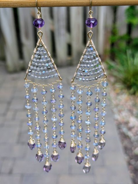 These super long chandelier earrings are all sparkle. Faceted labradorite rondelles are woven at the top with a few pyrite for accent. Then dozens of mystic topaz rondelles hang down and swing around showing off flashes of pink and green. They are topped with gorgeous fat amethyst rondelles and finished with scintillating amethyst marquises at the bottom. The earrings measure 5.125" from the top of the ear wire. Wrapped in gold filled wire. How To Make Chandelier, Baddie Jewelry, Chandelier Earrings Diy, Chandelier Jewelry, Stained Glass Earrings, Wire Jewelry Patterns, Beaded Stuff, Long Chandelier, Polymer Clay Flower Jewelry