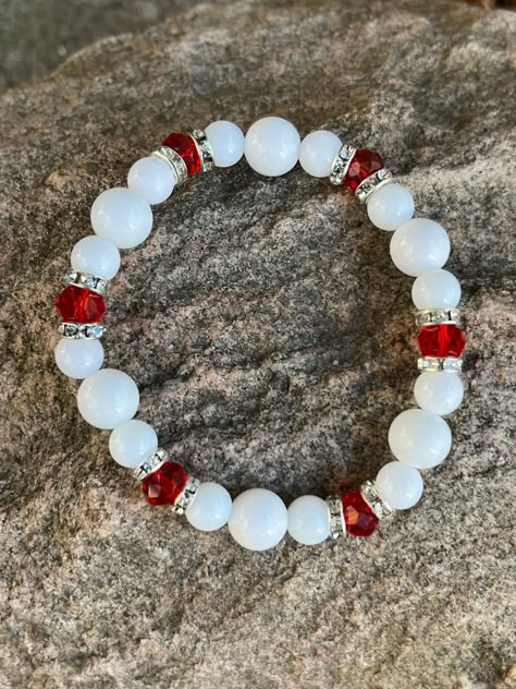 This bracelet is made with white glass beads, rhinestone spacers and red faceted beads. Note: Colors may vary depending on your monitor Shipping Info: All orders are shipped from Canada and they are sent through Canada Post.  If you would like expedited shipping it will cost more and reach out and I can give pricing. Within Canada: Sent regular mail with no tracking.  It can take 5-10 business days to arrive. United States: Sent with tracking  International: Sent International Air and on average Girly Bracelets, Braided Bracelet Diy, Holiday Bracelets, Red Beaded Bracelet, Bracelet Sets, Expensive Jewelry Luxury, Bracelets Design, Diy Bracelets Patterns, Beads Bracelet Design