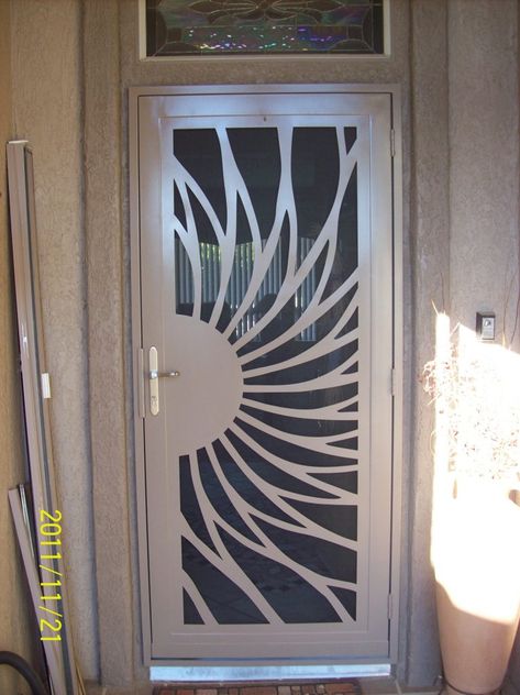 I just love how this security screen door looks like part of a flower or the sun. My husband and I are planning on installing a security screen door since we've had some break-ins in the neighborhood. Since I still want my home to look beautiful, we will have to find one like this since it has a beautiful pattern on it. Fancy Gate, Security Screen Doors, Front Door Security, Steel Screen, Security Screen Door, Steel Security Doors, Grill Gate Design, Metal Doors Design, Steel Door Design