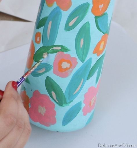 Learn how to transform a basic dollar store vase into a stunning spring-inspired with gorgeous painted flowers and leaves| Painted Dollar Store Vase using Glass Paints and transform it into a stunning decorative Vase. #dollarstorevase #dollarstorehacks #springinspired #floralvase #glasspaints Painting Vases Diy Ideas, Ceramic Vases Diy, Workshop Painting, Ottoman Diy, Diy Painted Vases, Flower Vase Design, Long Vases, Mug Painting, Light Blue Paints