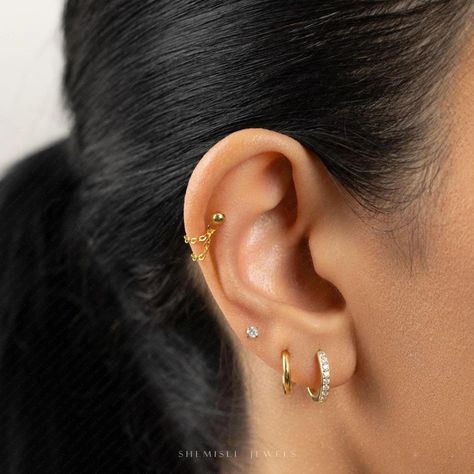 ✨New collection alert!✨ Elevate your summer look with our stunning Chain Helix Studs, White Stone Studs, and Hoops. Stack, mix, and match for a style that’s uniquely yours. Shop now and get 35% off $100 or 30% off $60! Hurry, limited time only! 💫 Link: https://shemisli.com/collections/earrings #Shemisli #FYP #Hoops #Studs #ShopNow #ShemisliJewels #SummerStyle #SummerJewels #HoopEarrings #StudEarrings #ChainForEarrings #ThinHoop #CZStoneStuds #Jewelry #OvalHoops #WhiteStoneStud #TriangleStu... Ear Pierce, Helix Studs, Earlobe Piercings, Lip Jewelry, Jewelry Care Tips, Tiny Jewelry, Double Piercing, Save Trees, Daith Earrings