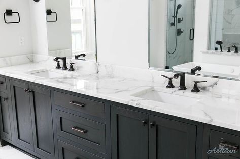 Black and white master bathroom designed with matte black faucets over a white and gray marble vanity countertop and black cabinets. Black Faucets, Black Cabinets Bathroom, Grey Bathrooms Designs, Marble Bathroom Floor, Matte Black Faucet, Black Vanity Bathroom, Black Faucet, White Marble Countertops, Vanity Countertop