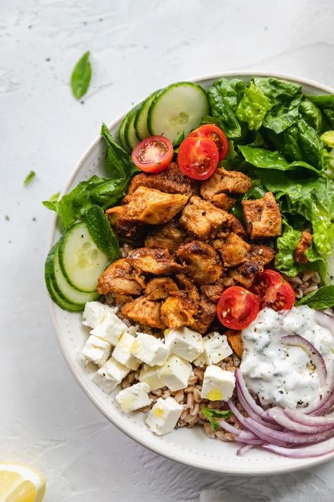 It's just like a chicken shawarma pita - but deconstructed! These Chicken Shawarma Bowls are made with a farro base, then topped with incredibly flavorful marinated chicken, shredded romaine, shaved red onion, cucumbers, cherry tomatoes, cubes of feta, fresh mint, and a super quick tzatziki sauce! #chickenshawarma #bowls #easymeal #tzatziki #healthy Quick Tzatziki Sauce, Chicken Shawarma Pita, Chicken Shredded, Romaine Salad, Power Bowls, Chicken Shawarma, Chicken Meal Prep, Tzatziki Sauce, Lunch Recipes Healthy