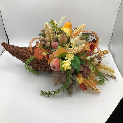 Brown Wicker Fall Cornucopia decorated with sugared pumpkin, fruits and fall flowers and leaves. The cornucopia basket measured 13 inches long x 7 inches wide. The total arrangement measured 21 inches long x 11 inches high x 14 inches wide( floral side). Cornucopia Basket, Thanksgiving Cornucopia, Fruit Centerpieces, Fall Floral Arrangements, Fall Fruits, Flower Festival, Artificial Flower Arrangements, Scottsdale Az, Fall Wreaths