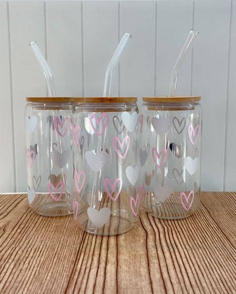 Home / Shop / VALENTINE HEARTS • 16 OZ GLASS CUP PrevNext Enjoy your favorite cold beverage in this cute glass cup! *All glasses come with bamboo lid and glass straw MATERIALS 16 oz can glass Bamboo lid Glass straw High quality permanent vinyl design GOODIES Comes with a free sticker Hand crafted applied design Made in the USA CARE INSTRUCTIONS *THESE GLASSES ARE NOT DISHWASHER SAFE* DO NOT SOAK. GENTLE HAND WASH ONLY. RECOMMENDED FOR COLD DRINKS ONLY Glass Things, Decal Ideas, Cute Coffee Cups, Cup Decal, Valentine Hearts, Glass Cups, Glass Straws, Business Idea, Custom Glass