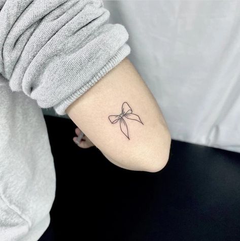 Cute Ribbon Tattoo, Simple Ribbon Tattoo, Minimalist Bow Tattoo, Bow Tattoo Back Of Arm, Cheer Bow Tattoo, Finger Bow Tattoo, Mini Bow Tattoo, Simple Bow Tattoo, Small Ribbon Tattoo