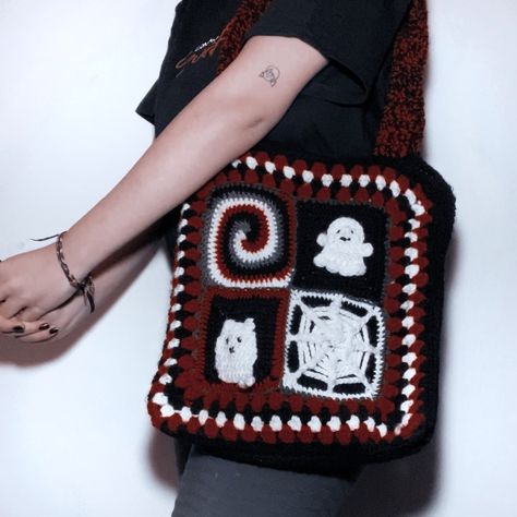 Black, white and red bag with four granny squares, one with a spiraling design, a cat, a ghost, and a spiderweb. crocheted by me. Grunge Granny Square, Alt Granny Squares, Goth Crochet Granny Square, Halloween Bag Crochet, Halloween Crochet Granny Square, Goth Granny Squares, Halloween Crochet Bag, Crochet Halloween Bag, Ghost Granny Square