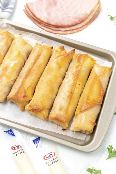 Ham and Mozzarella Cheese Sticks are a tasty and cheesy snack or appetizer. Ham and cheese stuffed inside a baked egg roll! #passion4savings #baked #oven #ham #cheese #eggrollwrapper #easy #quick #partyfood #appetizer #snack #schoolsnack Ham Cheese Sticks, Ham And Cheese Egg Roll Wrappers, Ham Egg And Cheese Roll Ups, Ham And Cheese Eggrolls, Ham And Cheese Egg Rolls, Ham And Cheese Sticks, Oven Ham, Ham And Cheese Roll Ups, Wild Recipes