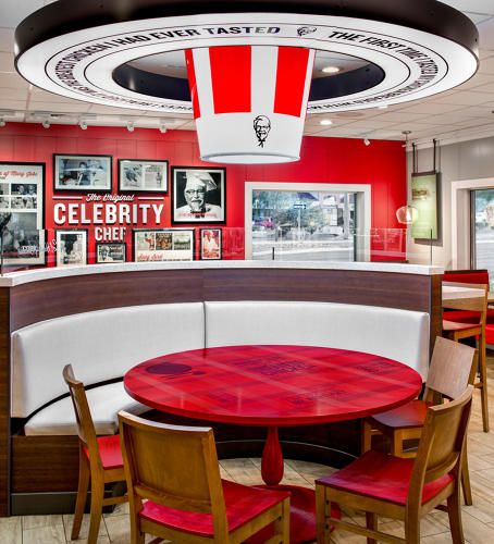 Cue up the calliope music, this circus has broken loose. KFC released images of its new store design created by the team at FRCH Design Worldwide. Although the first encounter may set off gut reactions, I think it begs to be picked apart with a little … Kfc Shop Design, Kfc Restaurant Interior, Kfc Interior Design, Kfc Design, Kfc Restaurant, Retail Architecture, Pizza Design, Decoration Restaurant, Supermarket Design