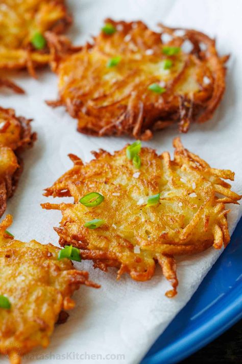 This latke recipe creates the crispiest potato fritters. Sprinkled with salt and dolloped with sour cream, these potato latkes are total comfort food. Potato Latkes With Frozen Hashbrowns, Baked Latkes Oven, Oven Baked Potato Latkes, Slice Potato Recipes, Latka Recipe Potato Latkes, Potatoe Latkes Recipe Jewish, Kinish Recipe Potato, Potatoe Latkes Recipe, Fried Potato Pancakes