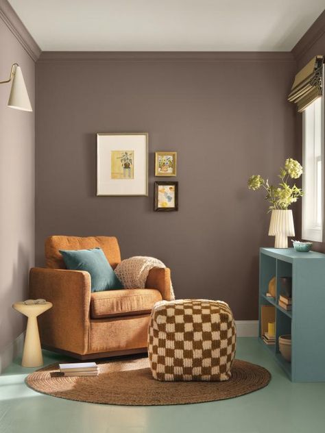 Is it brown? Is it gray? Is it purple? It's Nutshell, the moodiest color in the 2025 color collection. This brown paint with purple undertones is a chic choice on its own, and it grounds the other colors in the palette when they're used in the same space. (It's shown in this cozy sitting area with Quietude on the floor and Delft on the dresser.) Grey Paint With Purple Undertones, Purple Gray Paint, White Upper Cabinets, Warm Paint Colors, Exterior Color Palette, Cozy Sitting Area, Blue Green Paints, Hgtv Dream Home, Sherwin Williams Colors