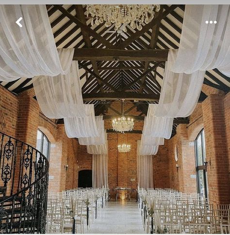 Wedding Ceiling Drapes And Lights, Rafter Decorations Wedding, Wedding Venue Ceiling Decor, White Drapery Wedding, Wedding Drapery Ideas Ceilings, Wedding Draping Ceiling, Tulle Ceiling Draping, Draping Fabric From Ceiling, Back Drops For Weddings Receptions