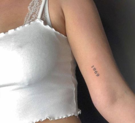 “1969” arm tattoo Size The Day Tattoo, Upper Arm Tattoo Minimalist, 1969 Tattoo Ideas, Year Arm Tattoo, Lots Of Small Tattoos Arm, Birthyear Tattoo On Arm, Tattoo Going Down Arm, Year Tattoo On Arm, Year Tattoo Placements