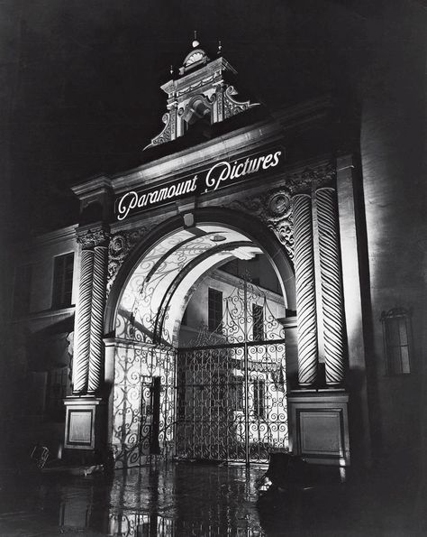 I don’t have a date on this night shot of the Paramount Pictures gate, but it looked like this for years. What I love about the way they’ve lit it. The lighting really shows the texture of the columns, and decorative motifs over the arch. And look at how the light at the back projects the intricate ironwork of the gates onto the walls of the arch. Really, is it any wonder this gate has become such an icon of the Hollywood film industry? Erich Von Stroheim, Hollywood Aesthetic, The Heist, Paramount Studios, Movie Studios, Hooray For Hollywood, Vintage Los Angeles, City Of Angels, California Dreamin'