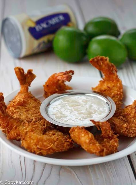 Learn the secret ingredients that make Red Lobster Parrot Bay Coconut Shrimp so good. You can make crispy, crunchy, flavor-packed fried shrimp at home with this easy copycat recipe. Dipping sauce too! #shrimprecipes #coconutshrimp #friedshrimp #copycat #copycatrecipes Red Lobster Coconut Shrimp, Coconut Shrimp Dipping Sauce, Coconut Shrimp Sauce, Shrimp Dipping Sauce, Red Lobster Shrimp, Peanut Dipping Sauce, Coconut Shrimp Recipes, Breaded Shrimp, Shrimp Sauce