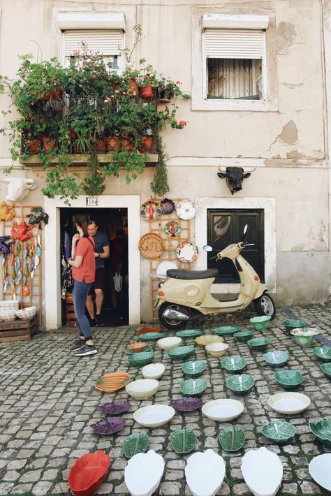 Lisbon's Alfama neighbourhood is one of the city's most picturesque areas. Rich in culture and history, Alfama is home to the infamous flea market and an array of quaint ceramic stores. Read our city guide online. Lisbon Cafe, Alfama Lisbon, Burgundy Walls, Unique Cafe, Ceramic Store, Port Area, Lisbon Travel, Portuguese Culture, Word Pictures