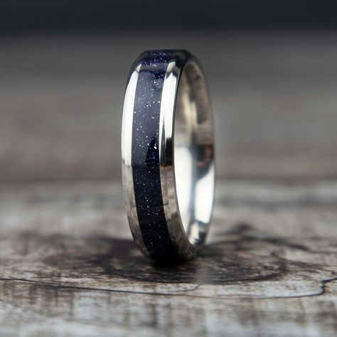 "\"Deep Starry Night\" is a Blue Sandstone ring with a tungsten or titanium band. It has a strong presence and appears like you're looking deep into space or the night. Great gift for him or her! Why buy from us? We do our best to make the ring buying process simple and easy for you. With this ring we include: ** Made With Love ** ** Lots of positive 5 star reviews ** ** FREE 1 Year Limited Warranty (See FAQ) ** ** A portion of the sale goes to support charity ** Buy with confidence knowing we w Men’s Galaxy Wedding Band, Night Sky Ring, Blue Sandstone Wedding Rings, Groom Wedding Rings For Men, Blue Sandstone Ring, Night Sky Wedding, Groom Wedding Band, Sandstone Ring, Stone Rings For Men