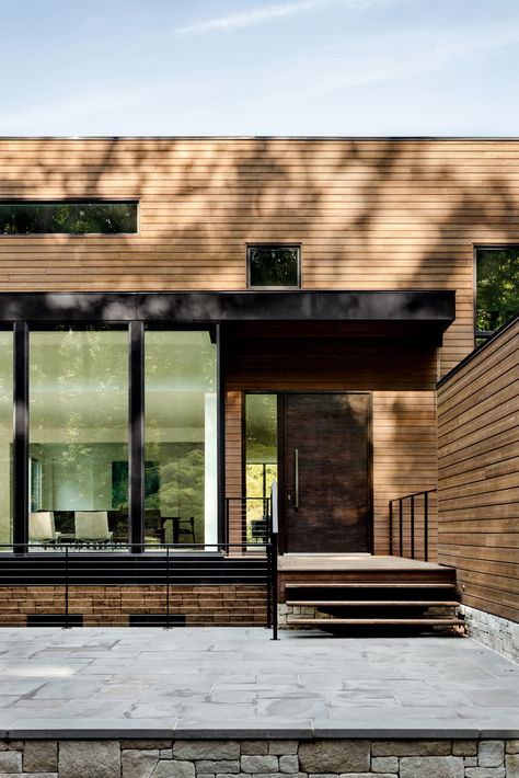 Abodo Vulcan Cladding in a Teak coating was specified to help blend this redesigned modernist home with its natural setting. #timberhouse #cladding #abodo Cantilever House, Cladding Exterior, Colored Dining Chairs, Wood Cocktail Table, Dc United, Wood Cladding, House Blend, Timber Cladding, Exterior Cladding