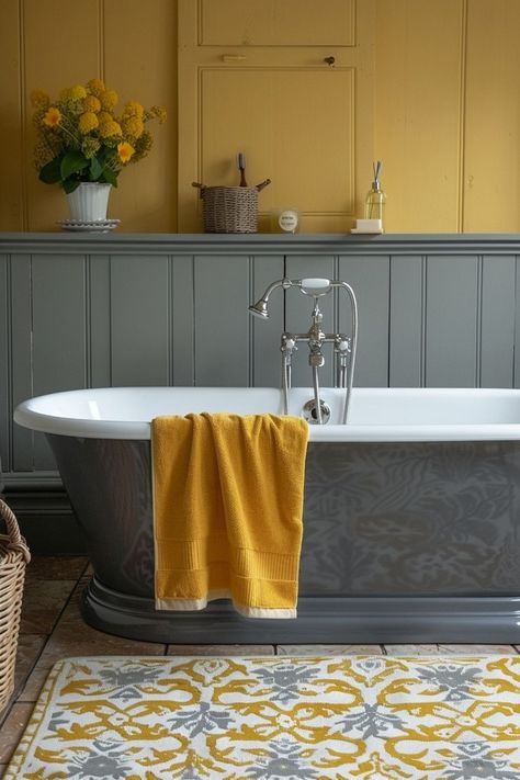 Subtle Yellow & Gray bathroom decor combines soft yellow and sleek gray for a balanced, modern look. The muted yellow adds warmth to the space, creating a calm yet stylish atmosphere. For more Subtle Yellow & Gray designs, click or tap here. Yellow And Sage Bathroom, Yellow Blue Bathroom Ideas, Ochre Bathroom, Mustard Yellow Bathroom Ideas, Yellow Gray Bathroom, Mustard Yellow Bathroom, Yellow And Blue Bathroom, Mustard Bathroom, Cottage Core Bathroom