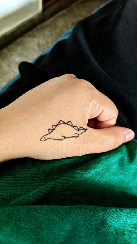 #tattoo #dinosaurtattoo #handtattoo #cutetattoo explore tattoo Sleeping Dinosaur Tattoo, Sleeping Dinosaur, Wine Glass Tattoo, Dinosaur Tattoo, Tiny Dinosaur, Dinosaur Tattoos, Dinosaur Drawing, Story Book, Infinity Tattoo