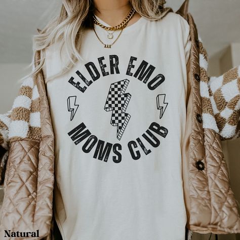 This comfy shirt is the perfect gift for the elder emo in your life. You know, the one that has never stopped loving those old pop punk hits and still goes to every reunion concert/festival they can find. Maybe you're the elder emo that can't get enough of that nostalgia. Gift yourself with this comfy shirt and go jam out. Each shirt is custom made at the time you order it. Please note: Colors may appear slightly different in-person due to computer/phone screens.  SIZE: ❤ This is a regular unise Punk Rock Shirts, Elder Emo, Scene Shirt, Emo Phase, Punk Shirt, Mama Style, Comfy Shirts, Concert Shirts, Rock Shirts