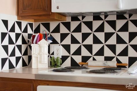 This patterned kitchen backsplash makeover has the look of trendy and expensive cement tiles but (1) didn't involve painting the existing tiles, (2) is SUPER affordable, and (3) can be completed in one afternoon! Black White Backsplash, Black And White Tile Backsplash, Geometric Tile Backsplash, Kitchen Tile Diy, Black And White Backsplash, Outside Tiles, Vinyl Backsplash, White Tile Backsplash, White Backsplash