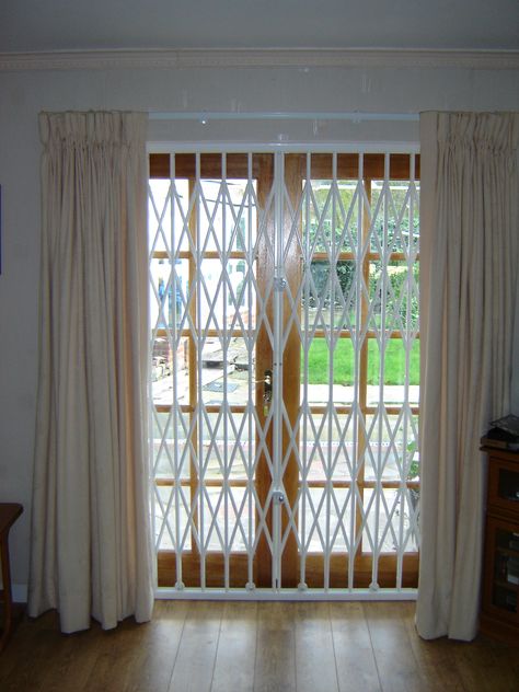 RSG1000 Retractable Patio Door Security Grilles fixed to the back of the main door of a living room at a residential property in Tooting Security Sliding Doors Patio, Balcony Sliding Door Ideas With Grill, Sliding Door Security Ideas, Sliding Grill Door Design, Sliding Main Door, Sliding Glass Door Security, Collapsible Door, Sliding Grill, Collapsible Gate