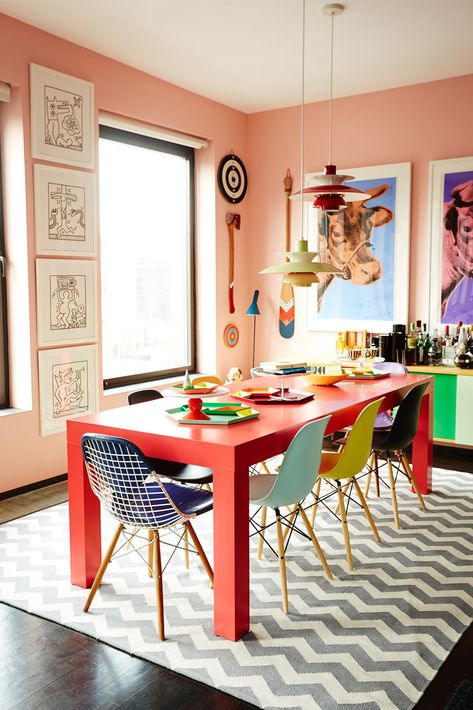 Meet The CEO Who Mixes Bold Colors Like A Boss #refinery29  http://www.refinery29.com/bradford-shellhammer-home-tour#slide-9  Mismatched, candy-colored Eames chairs are the perfect foil for a bold, red Parsons-style dining table underneath a makeshift chandelier composed of Louis Poulsen PH 50 pendant lights hung at staggered heights. Colorful Dining Room Decor, Colorful Apartment, Dining Room Colors, Deco Retro, Rooms Ideas, Chaise Design, Colorful Home, Dining Room Ideas, 로고 디자인