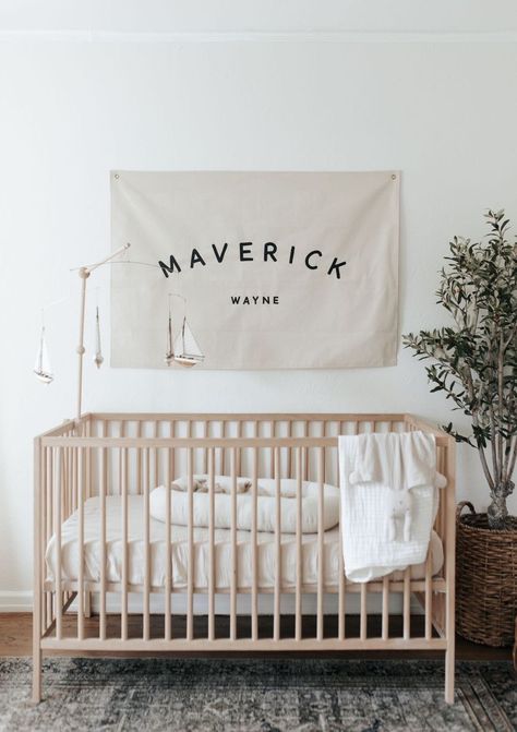 Simple and classic nursery, featuring hand painted name banner Nursery Name Flag, Name Flag Banner Nursery, Nursery Name Banner, Baby Boy Name Signs For Nursery, White Crib Boy Nursery, Nursery Ideas Nautical, Name Over Crib, Over Crib Decor, Baby Name Decorations