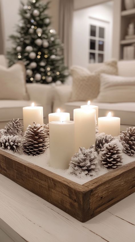 Wooden tray with white candles and snow-covered pine cones, enhancing a cozy living room's elegant winter decor for White Christmas Inspiration, Decor For Tables In Living Room, White Winter Christmas Decor, Living Room Filler Ideas, Gorgeous Christmas Decor, Winter Wonderland Home Decorations, Winter Themed Home Decor, Transition Christmas To Winter Decor, Winter Decorations Not Christmas