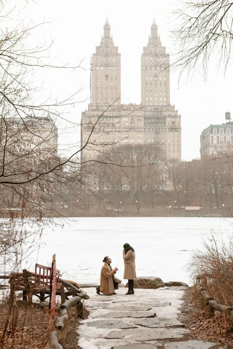 A man proposes on one knee with the Eldorado as a backdrop by the frozen Lake in Central Park New York City. Nyc Winter Proposal, New York Winter Proposal, Proposal Ideas New York, Proposal New York, Proposal Central Park, Gazebo Proposal, Central Park Couple, New York Facts, Proposal Pics