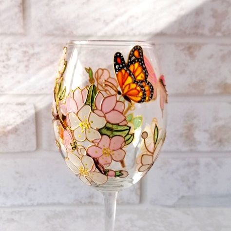 This listing is for 1 Cherry blossom wine glass with bright butterflies! It would be a great gift for wine lover for Anniversary, Birthday, Wedding... The wine glass is hand painted by me and I'll gladly personalise it with names or wedding date or your text. Measurements: About 440 ml / 15 oz Height 22 cm / 8,7 inch Please contact me for any additional information or to request a custom order. I will be happy to create something especially for you! Glasses care advice: hand washing glasses in w Diy Glasses, Custom Wine Glass, Glass Painting Designs, Flower Box Gift, Diy Jar Crafts, Hand Painted Wine Glasses, Painted Glasses, Personalized Mother's Day Gifts, Painted Wine Glasses