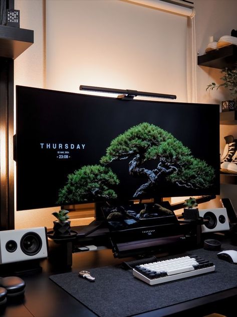 Desk setup in a dark room with two monitors displaying vibrant images, surrounded by speakers, headphones, and neatly arranged decorative items. The workspace is enhanced with mood lighting, personal touches like action figures, and a bonsai tree, creating a modern yet cozy environment. Bonsai Wallpaper, Phone Backgrounds Aesthetic, Game Room Ideas, Computer Desk Setup, Home Studio Setup, Video Game Room Design, Desktop Setup, Backgrounds Aesthetic, Aesthetic Space