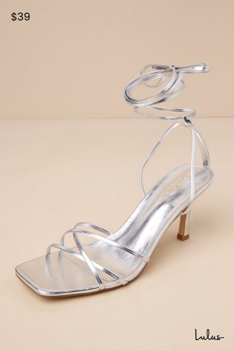 Make an entrance unlike any other with a fabulous look like the Lulus Lawrance Silver Lace-Up High Heel Sandals! Shiny faux leather shapes these trendy lil' heels that feature a classic square-toe footbed, a network of slender straps that create a peep-toe upper, and matching straps that weave through a supportive heel strap to wrap and tie above the ankle. 3. 25" wrapped stiletto heel. Cushioned insole. Rubber sole has nonskid markings. Man made materials. Imported. Lulus | Lawrance Silver Lace Silver Heeled Sandals, Strappy Heels For Summer Events, Silver Heels With Sculpted Heel In Synthetic Material, Silver Synthetic Heels With Sculpted Heel, Silver Heels For Summer Events, Silver Heels With Reinforced Heel For Spring, Silver Synthetic Heels With Wrapped Heel, Silver Sleek Heels For Summer, Chic Silver Strappy Heels