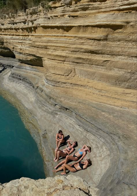 Four girls laying on a rock in Greece Corfu Greece Picture Ideas, Corfu Picture Ideas, Greece Island Aesthetic, Greece Girls Trip, Corfu Greece Aesthetic, Sidari Corfu, Greece Aesthetics, Greece Girl, Greece Corfu