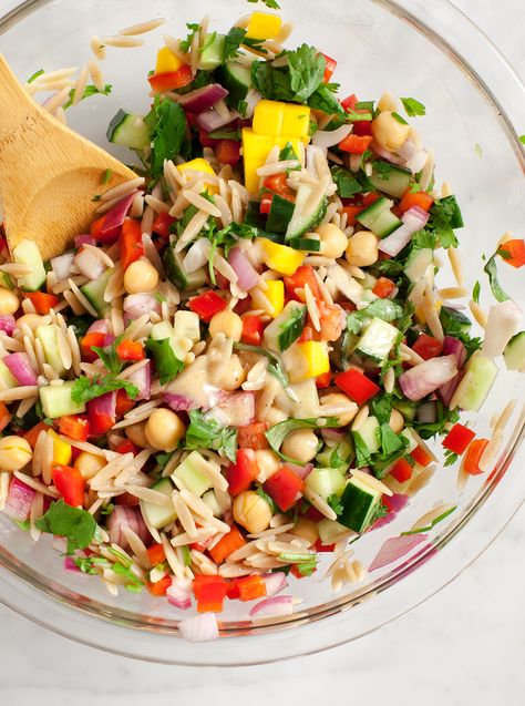 This orzo pasta salad is the perfect dish for a summer picnic! With a creamy spiced tahini dressing, fresh herbs, mango, and lots of veggies, it's fresh, fun & easy to make. Great for packing for lunch or serving with anything you're grilling! | Love and Lemons #lunch #salad #sidedish #pastasalad #veganrecipes Orzo Salat, Easy Picnic Food, Orzo Salad Recipes, Make Ahead Salads, Orzo Pasta Salad, Orzo Salad, Best Salad Recipes, Orzo Pasta, Tahini Dressing