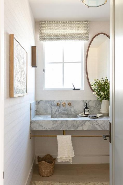 Bathroom features a gray marble sink vanity with brass towel bar and antique brass faucet under a window with oval mirror. Marble Sink Vanity, Brooke Wagner Design, Brooke Wagner, Antique Brass Faucet, Brass Towel Bar, Small Toilet Room, Bathroom Shower Design, Bath Inspiration, Marble Sink