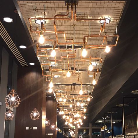 Copper Pipe Lighting - Stellex Manufacturing Ltd Copper Pipe Lighting, Industrial Lobby Design, Copper Pipe Art, Conduit Lighting, Greenhouse Kitchen, Boutique Lighting, Lamp Pipes, High Ceiling Lighting, Industrial Pipe Lamp