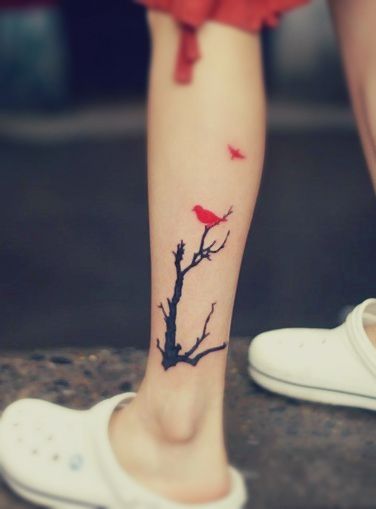 A tattoo featuring a red bird resting on a black tree and another bird flying away Red Bird Tattoo, Tree With Birds Tattoo, Red Bird Tattoos, Watercolor Bird Tattoo, Tattoo Bird, Free Tattoo Designs, Bird Tattoo, Calf Tattoo, Free Tattoo