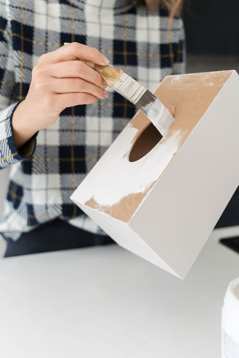 Looking for an inexpensive stylish tissue box idea? Look no further than this plain craft tissue box design using Mod Podge and tissue paper! You only need six materials to make this easy tissue box cover! Here you see Gina from Style Curator using white paint on the tissue box to create a good base. To find the full tissue box DIY, click on the pin! Wood Kleenex Box Cover, How To Make A Tissue Box Cover, How To Make Tissue Box Diy, Tissue Box Decoration Ideas, Tissue Paper Box Diy, Painted Tissue Box Covers, Craft Ideas With Popsicle Sticks, Diy Kleenex Box Cover, Ideas With Popsicle Sticks