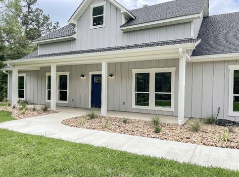 Light Grey Vertical Siding, Light Grey Modern Farmhouse Exterior, Light Grey Siding White Trim, Light Gray Ranch House Exterior, Light Grey Houses Exterior, Gray Blue Siding House, Light Grey House Black Roof, Gray Exterior House Colors Ranch Style, Light Gray Board And Batten Exterior