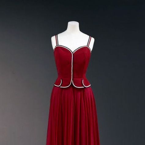 @vintagefashionguild on Instagram: "Evening dress by Coco Chanel in 1939.  This stunning evening dress from Chanel's Spring/Summer 1939 collection is a perfect blend of elegance and modernity. Made of red grosgrain silk and chiffon, it features a sleeveless, tight-fitting bodice with black, white, and red selvedge ribbon accents. The full chiffon skirt flows beautifully from inverted pleats. This dress exemplifies Chanel's genius in creating elegant yet sporty eveningwear for the modern 1930s woman.  Learn more about 1930s fashion at VFG Fashion Timeline (link in bio)  Credit: V&A Museum  #1930sFashion  #CocoChanel  #VintageStyle  #FashionHistory  #Chanel1930s  #TimelessElegance  #RetroGlamour  #VFG" 1930s Woman, Fashion Timeline, 1930s Dress, Chanel Spring, 1930s Fashion, Chiffon Skirt, White And Red, Fashion History, Coco Chanel