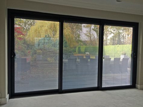 A Smart Visoglide Plus triple track sliding door complete with integral blinds to the sealed units, recently installed at property in Wakefield. Garage To Living Space, Door Dividers, Sliding Door Blinds, Security Doors, Glass Extension, Door Blinds, Aluminum Blinds, Sliding Glass Doors, Sliding Patio Doors