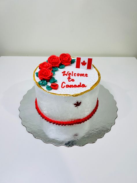 Small Round Welcome cake with Canada flag and maple leaf decorated nicely with red flowers and edible gold paint. Welcome To Canada Cake, Cack Designe, Canada Flag Cake, Edible Gold Paint, Welcome Cake, Canada Cake, Welcome To Canada, Flag Cake, Edible Gold