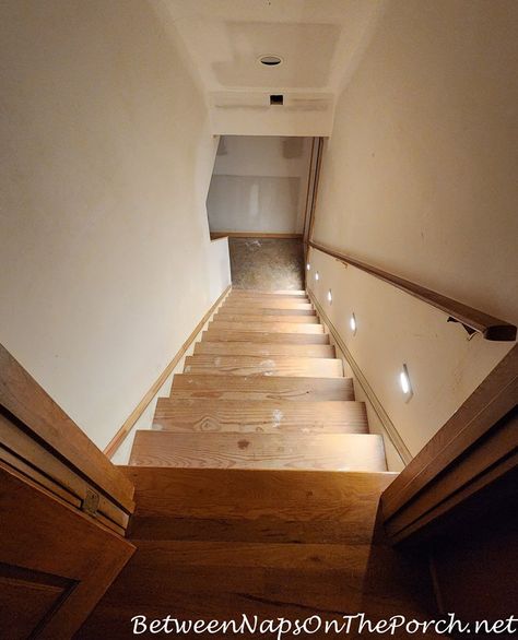 Staircase Going Down To Basement, Lights Going Up Stairs Staircases, Basement Stair Colors, Staircase Makeover Basement, Basement Stair Lights, Basement Staircase Lighting, Basement Step Lighting, Exposed Basement Stairs, Adding A Staircase To Attic