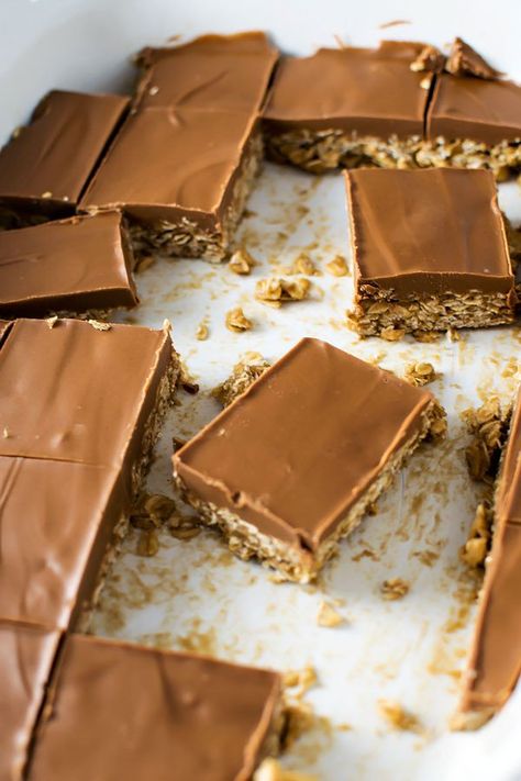 Mock Baby Ruth Bars! The classic way to make Baby Ruth bars at home: a sugary oatmeal no-bake cookie base that's covered in a rich chocolate butterscotch topping. | HomemadeHooplah.com Greek Kale Salad, Butterscotch Topping, Baby Ruth Bars, Bars At Home, Kale Feta, Homemade Greek Dressing, Oatmeal No Bake Cookies, Greek Dressing, Cookie Base