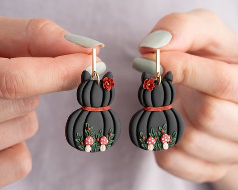 The earrings are made from polymer clay. If you are looking for different and stylish earrings, here you are. I dreamed of them. These earrings are not available anywhere else. I used 24 k gold plated material. they will never irritate your ears. You must be excited to wear these stylish and designer earrings. because it will probably be just you. Halloween clay earrings | |halloween jewelry |black cat  earrings |spooky earrings |handmade earrings Material : 24K gold plated bar post ,polymer cla Hocus Pocus Polymer Clay Earrings, Earrings Handmade Polymer Clay, Fall Earrings Clay, Halloween Polymer Clay Earrings, Halloween Earrings Polymer Clay, Halloween Clay Earrings, Fimo Halloween, Cat Pumpkins, Flowers And Mushrooms