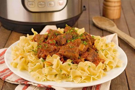 Our Hungarian Beef Goulash is an old family recipe that's been adapted for the Instant Pot electric pressure cooker. Richly flavored with sweet paprika, this hearty beef dish is delicious served over egg noodles or Hungarian Dumplings (Nokedli). #maindish #dinner #recipe #beef Hungarian Dumplings, Hungarian Beef Goulash, Noodles Crockpot, Beef And Noodles Crockpot, Beef Healthy Recipes, Beef Instant Pot, Trendy Recipes, Hungarian Goulash, Beef Goulash