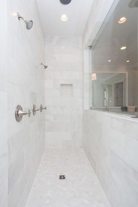 Long walk in shower displays honed white marble tiles in a narrow design featuring side by side shower heads. Double Headed Showers Walk In, Dual Shower Heads Master Baths Walk In, Dual Shower Heads Master Baths, Double Shower Head Master Baths, Double Shower Head, Shower With Bench, Kids Bedroom Remodel, Shower Conversion, Small Bedroom Remodel